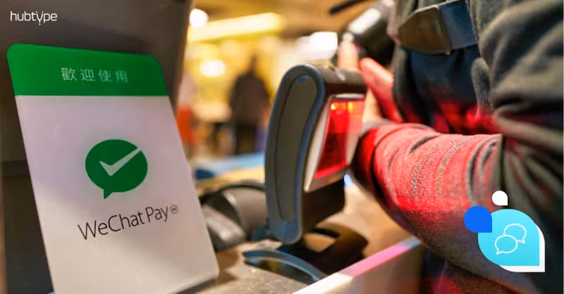 Person using WeChat Pay scanner at checkout with mobile payment at retail store.