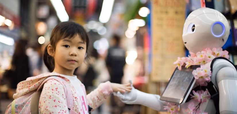 Child interacting with robot assistant in public setting, showcasing chatbot technology and human-robot interaction.
