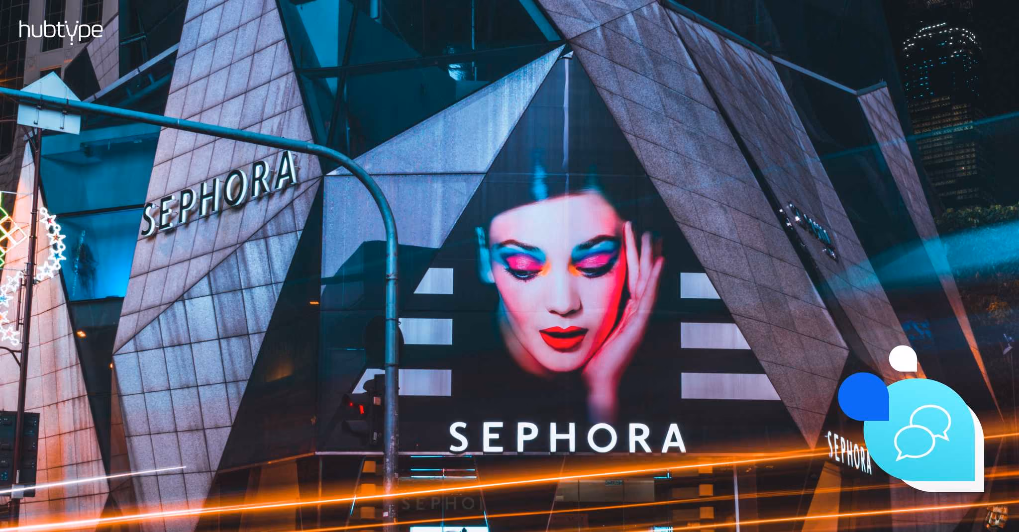 Sephora store exterior at night showcasing vibrant makeup advertisement, illustrating urban beauty branding.