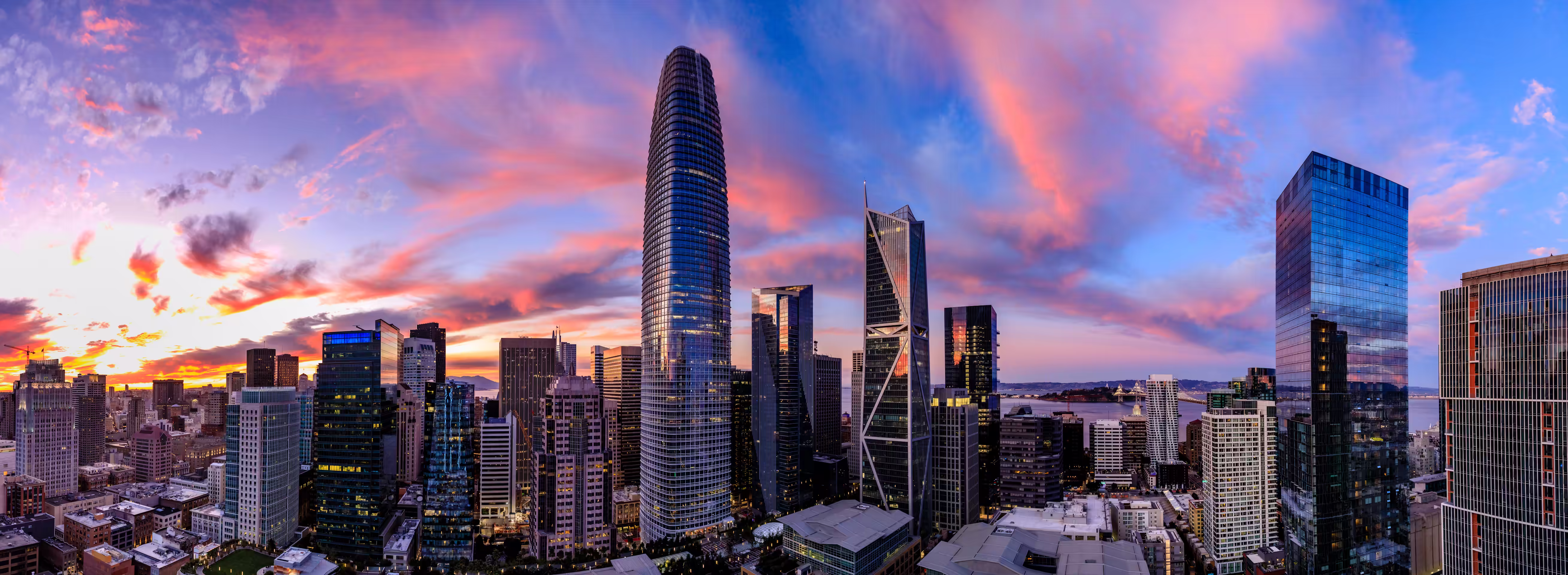 San Francisco skyline at sunrise including Salesforce Tower and the Bay Bridge