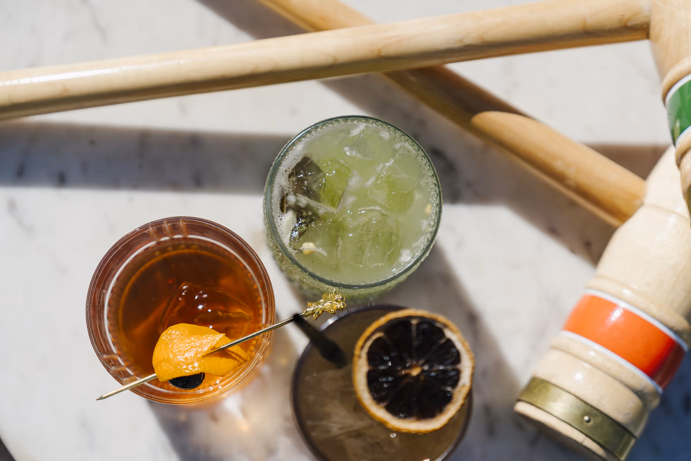 Overhead view of craft cocktails on marble surface at Stewart's Cocktail Club