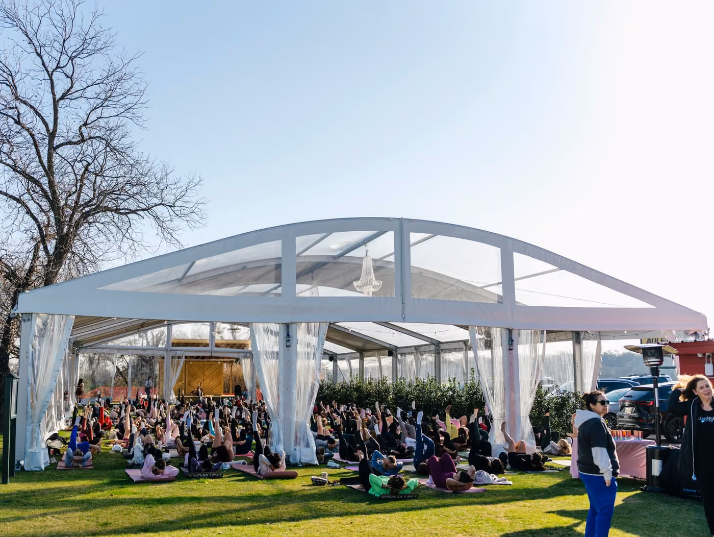 Outdoor fitness class on the lawn beneath Stewart's clear-span event tent
