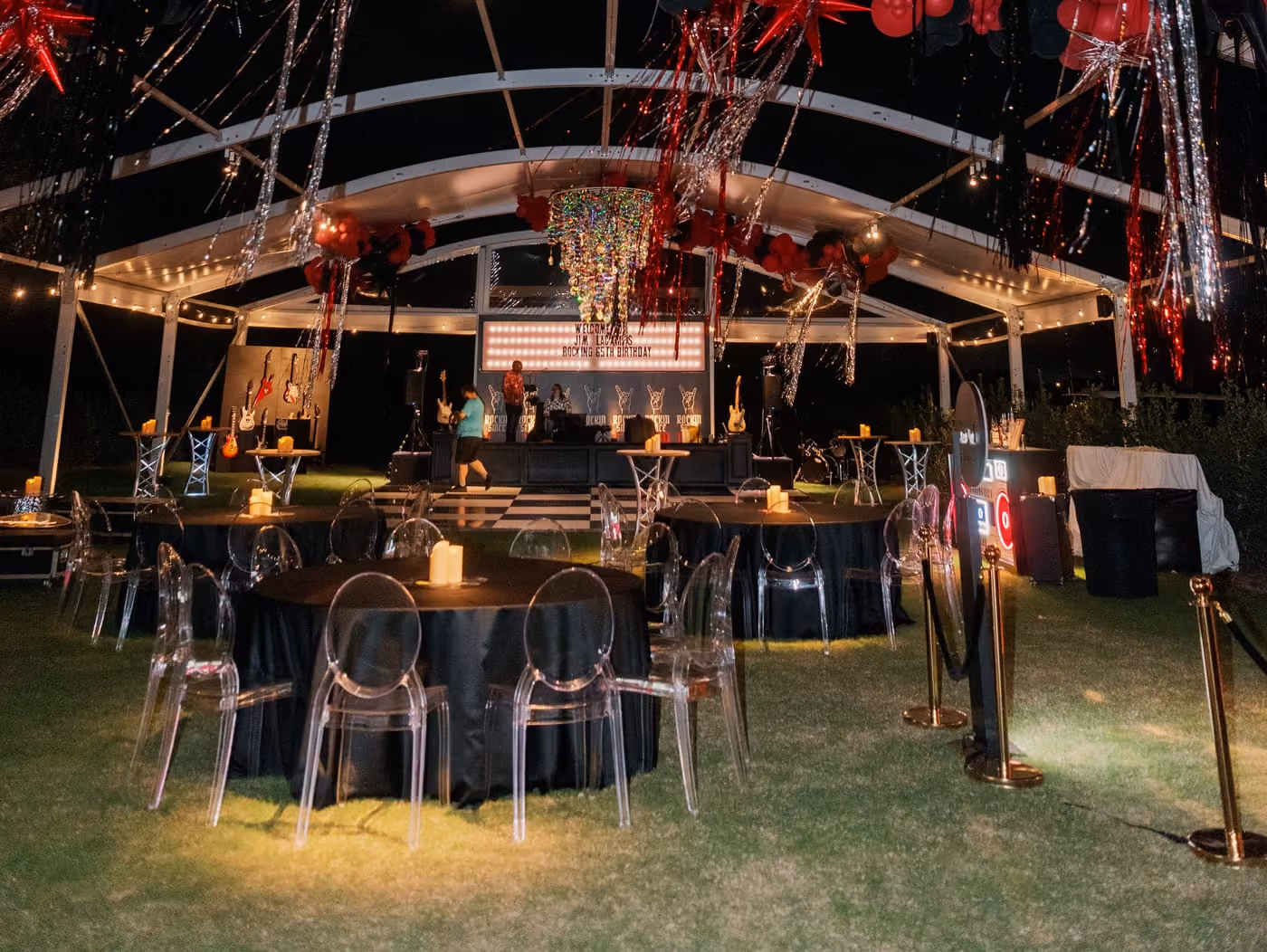 Red and black balloon installation above the bar at a birthday party under the tent