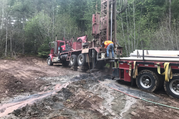 Hansen Drilling drill rig on wet hillside