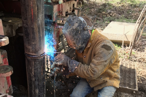 Hansen Drilling drill rig on wet hillside