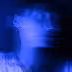 Blurred portrait of a person with blue lighting creating a ghostly effect.