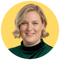 Portrait of a woman with chin-length blonde hair, wearing a green velvet turleneck sweater.