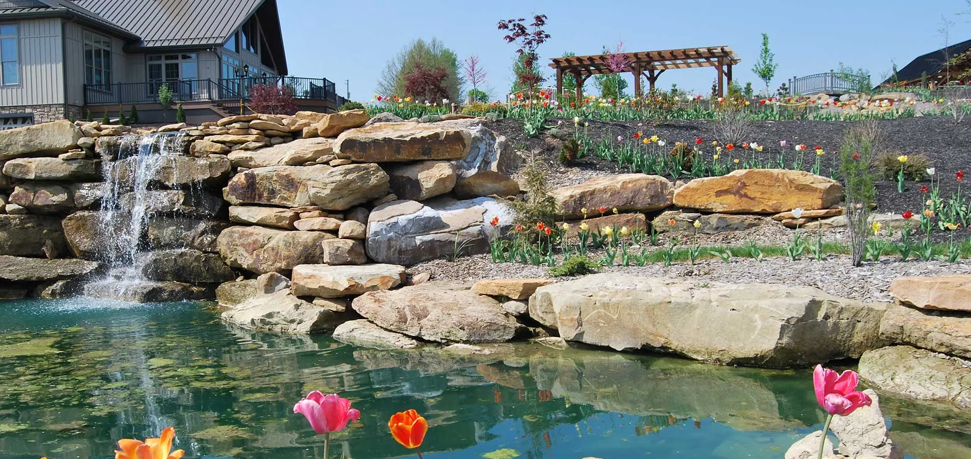 homestead campus stone fountain and flowers