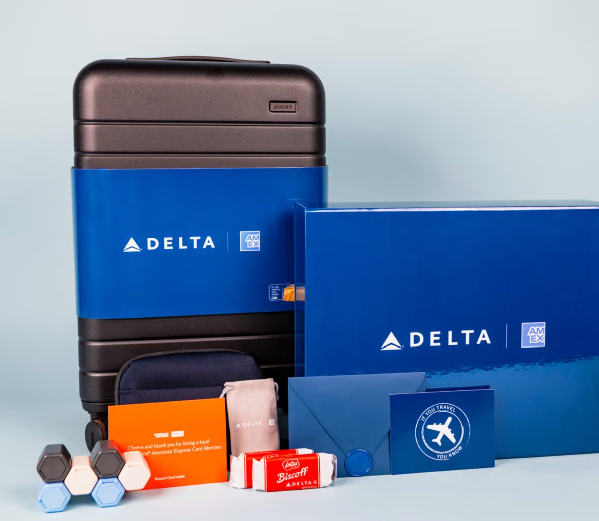 Delta x Amex loyalty kit with a branded carry-on suitcase, blue gift box, and travel accessories