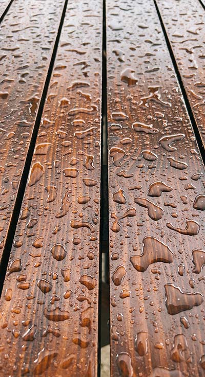 Water beading on wooden deck boards