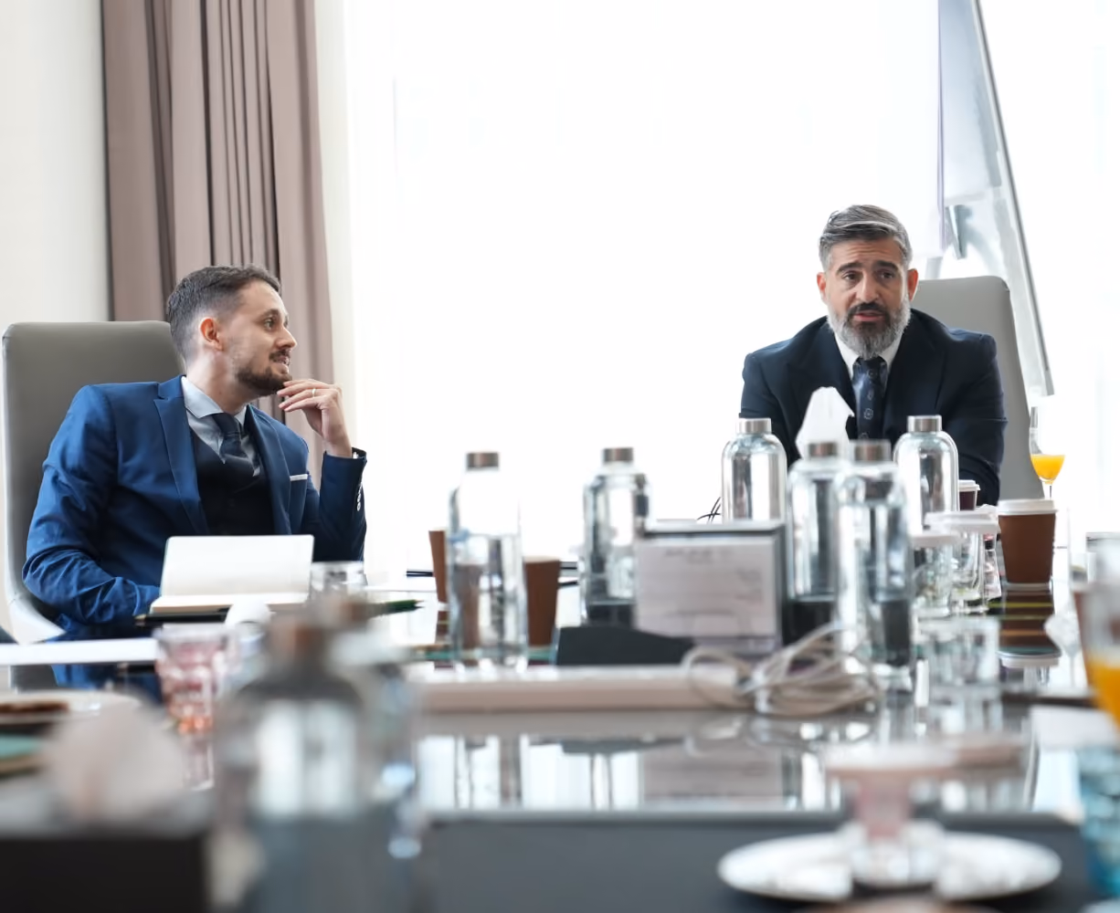 Advisors discussing an investment strategy in a business meeting.