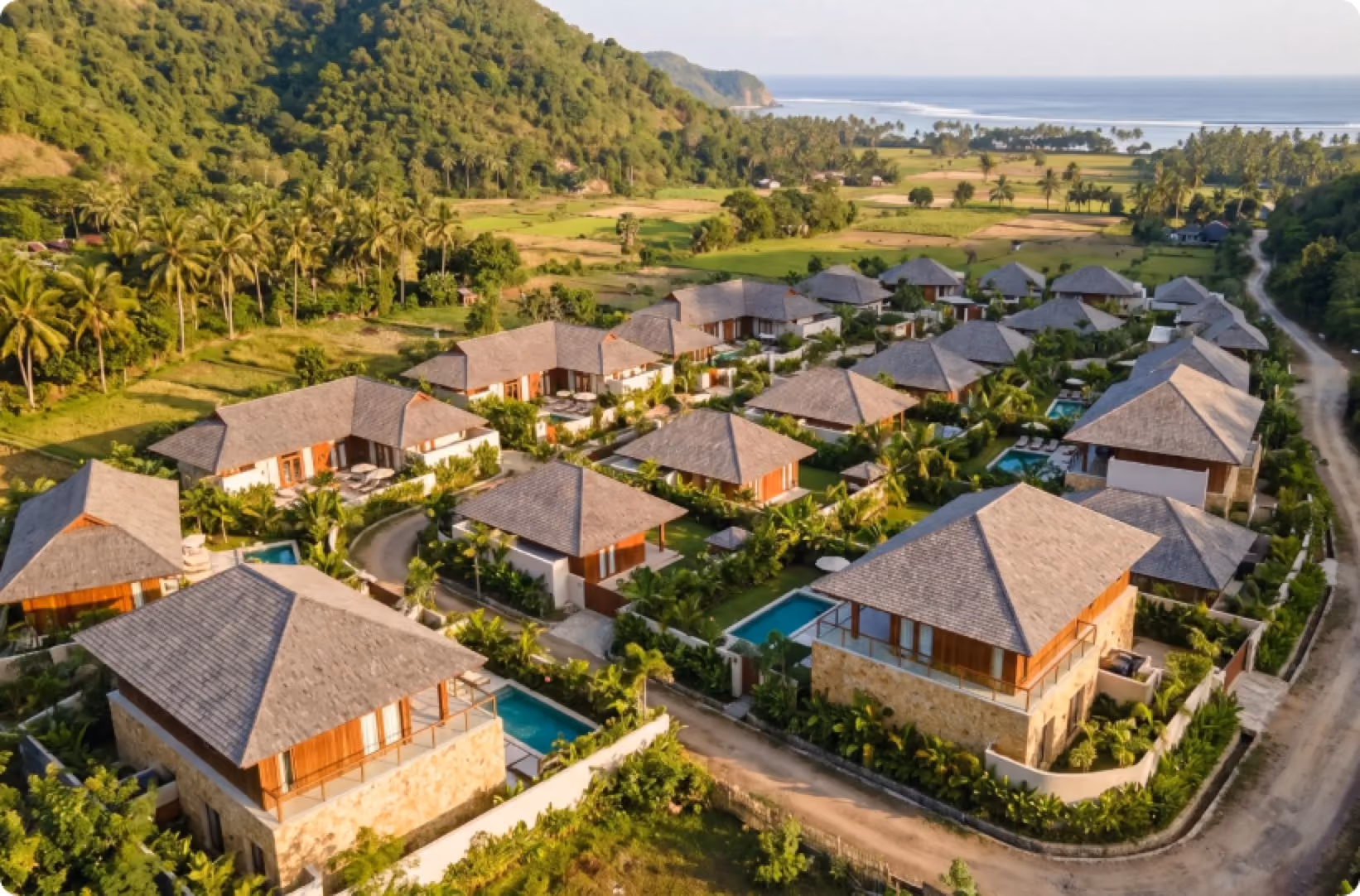 Aerial view of Baraca Village villas among hills and rice fields