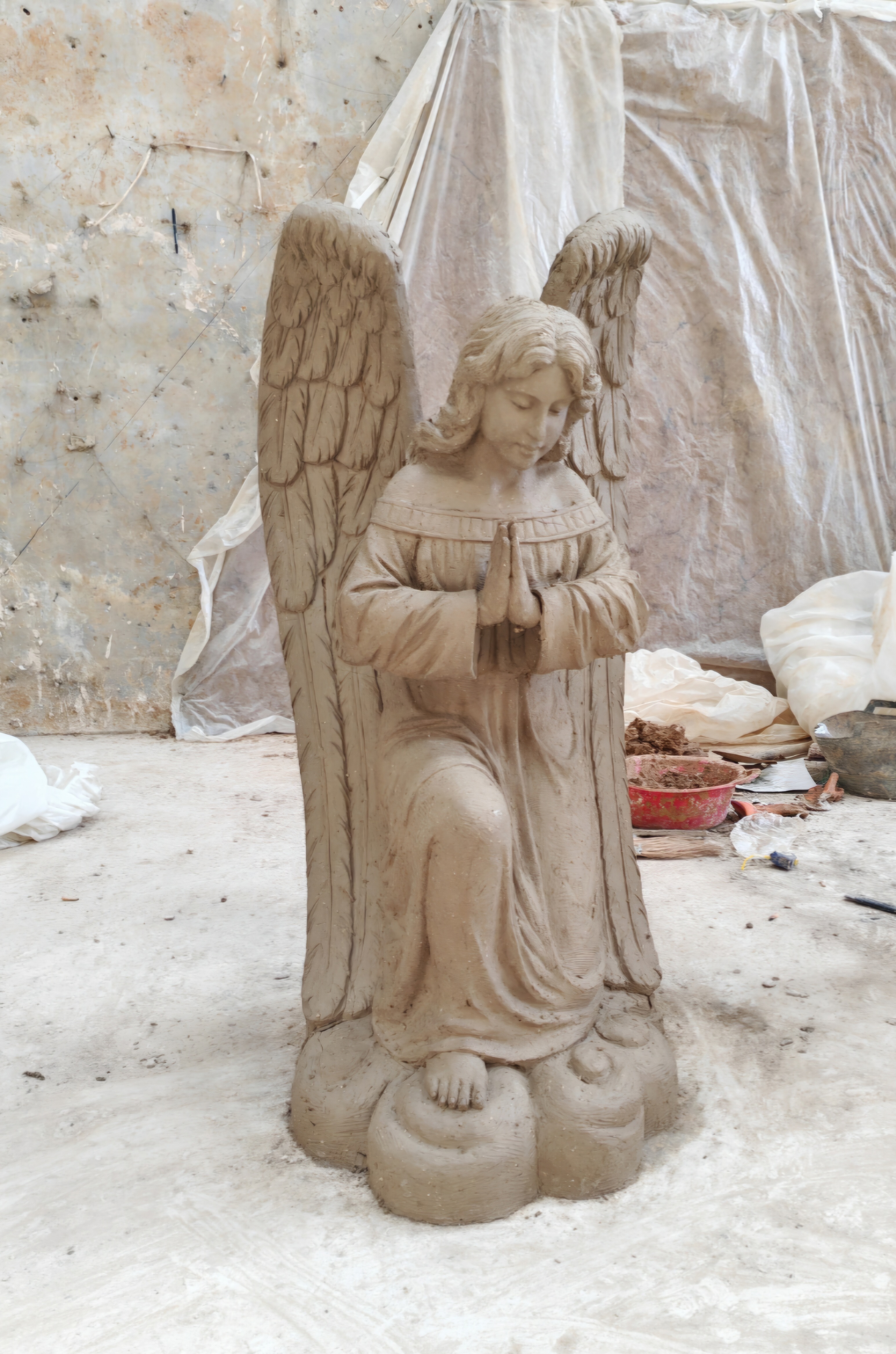 A clay mold of an angel that is ready to be cast in bronze, marble, fiberglass, or carved from wood.