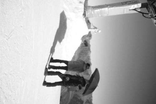 fashion photographer taking picture of the model on the mountain