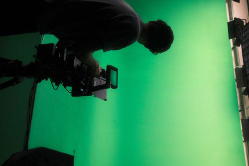 dop operating camera on green screen studio