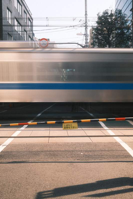 Train crossing the railway in the middle of the city in Tokyo