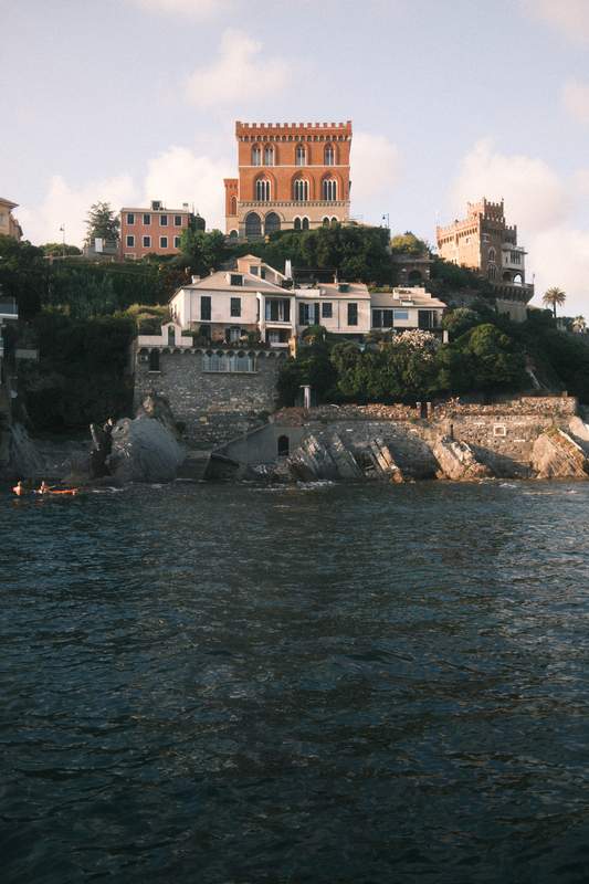 Colorful houses on a cliff right above the ocean in Genova