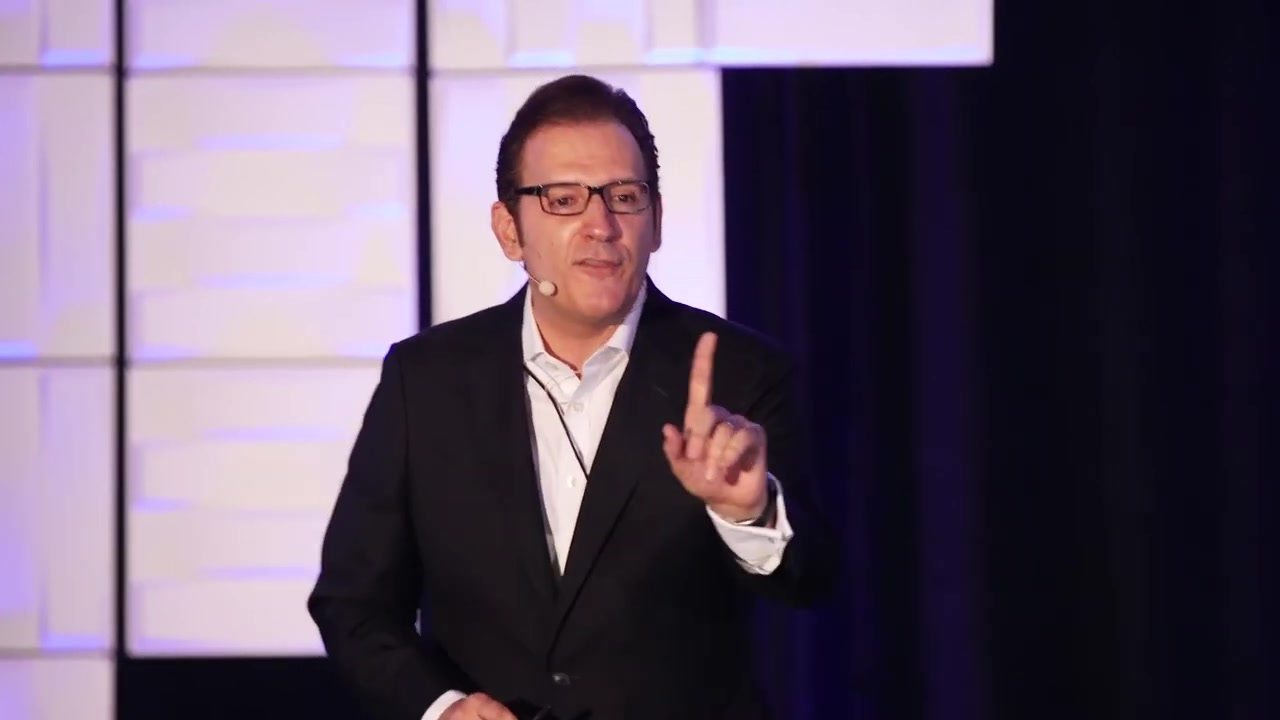 Glenn Llopis making a point on stage