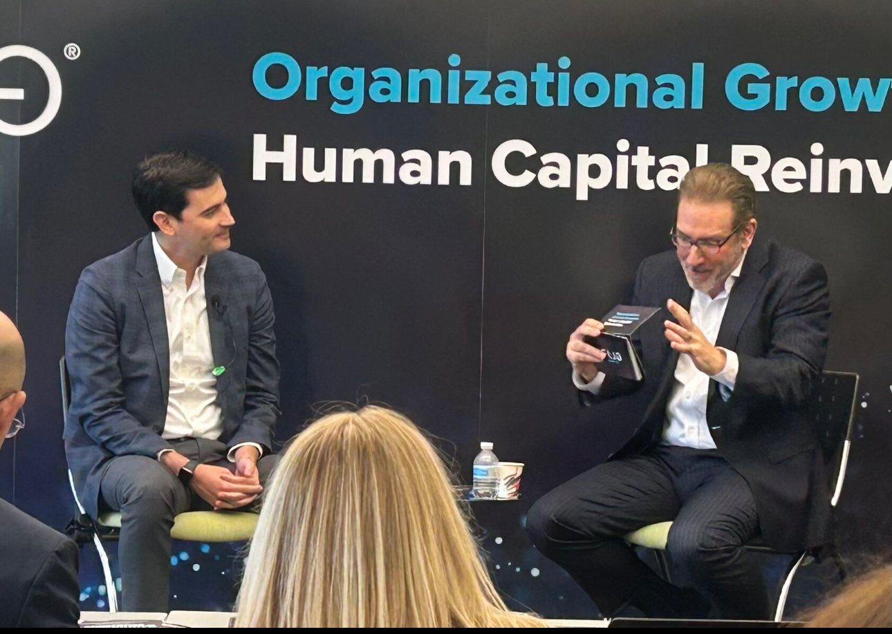 Glenn Llopis on stage with a young executive at the Season 6 forum