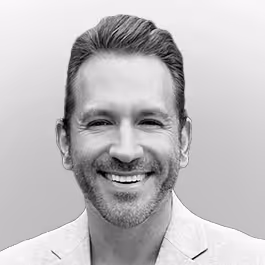 Black and white headshot of Glenn Llopis smiling in a circular frame