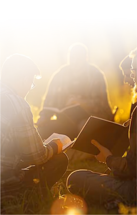 Orthodox Christians reading Holy Scripture together amidst a peaceful outdoor sunset scenery together.