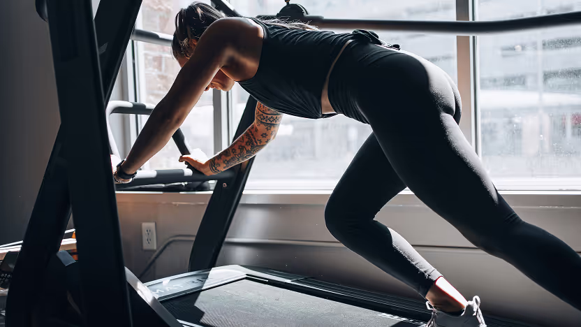 A woman is doing a workout on a treadmill.