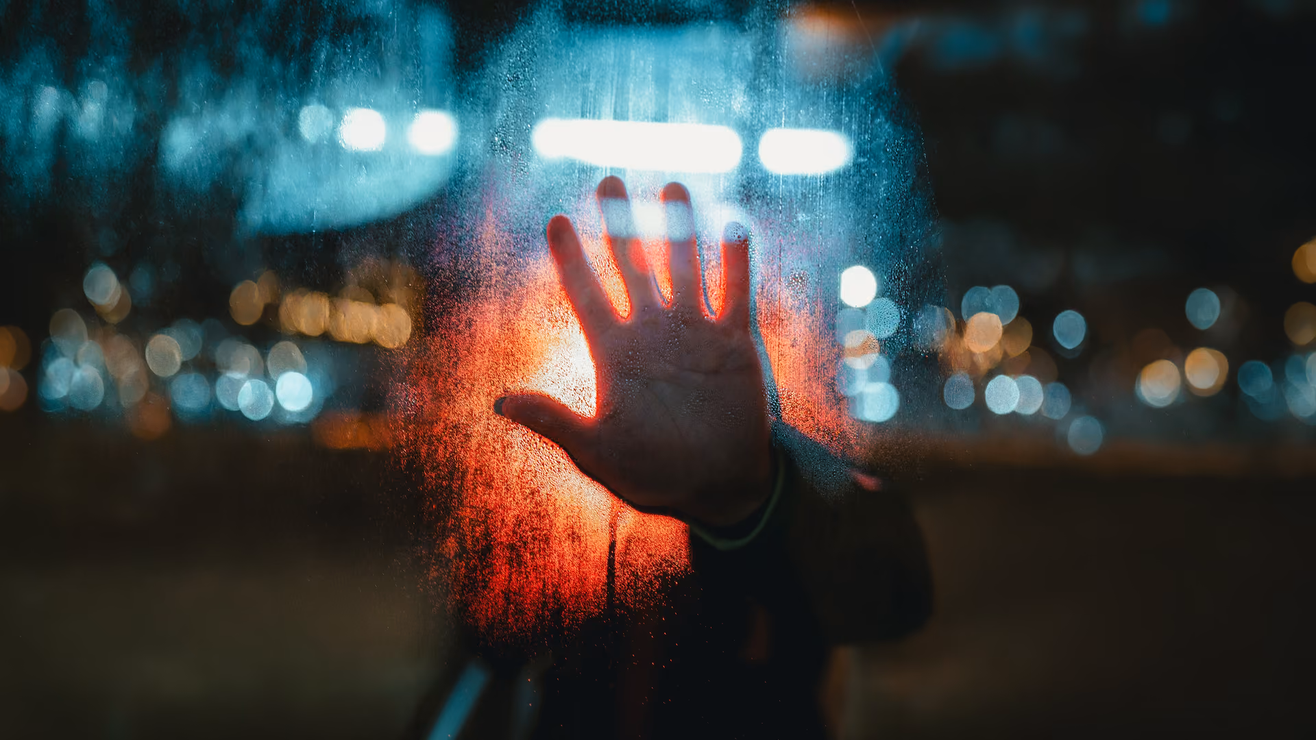 hand on a window glass