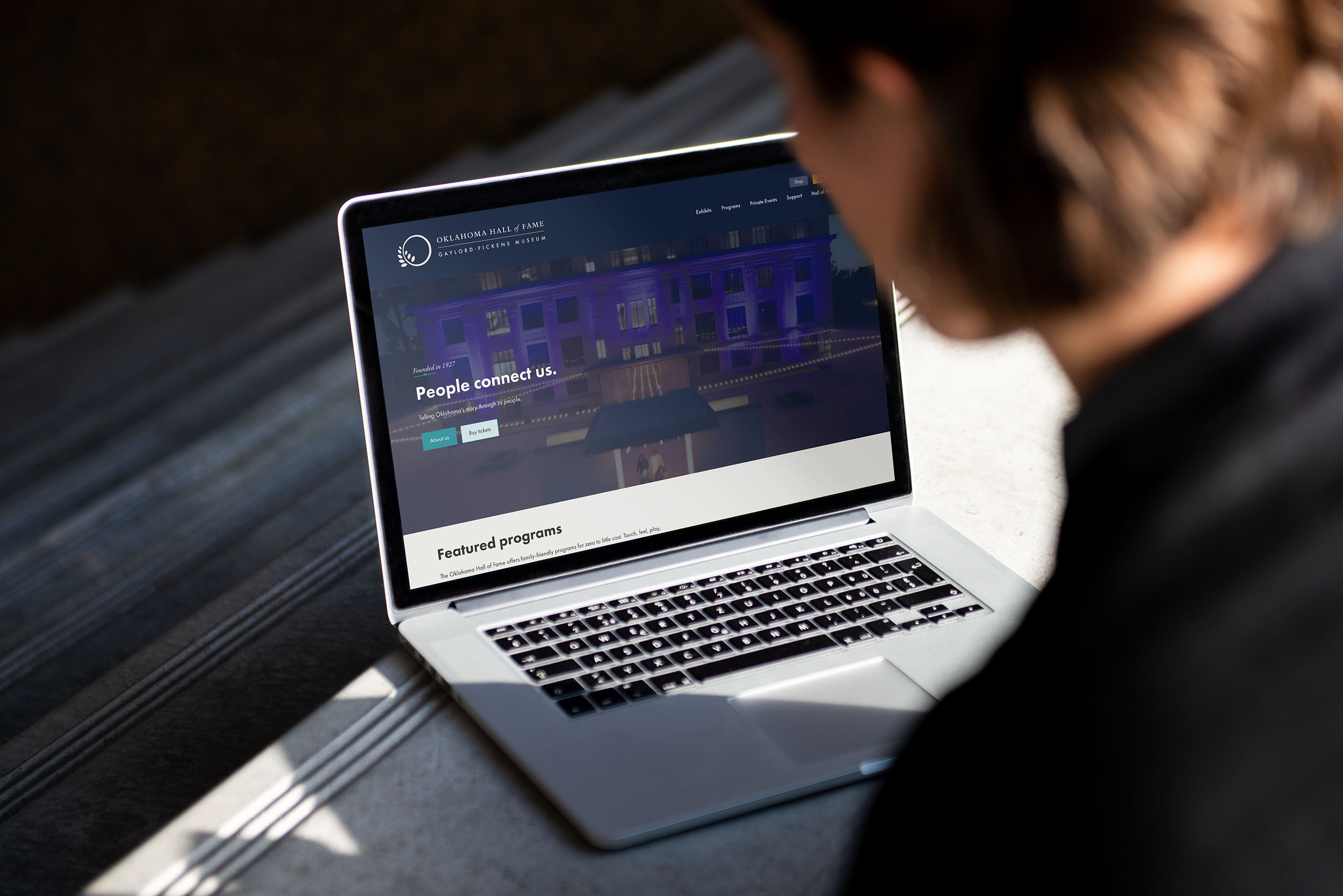 Person viewing the Oklahoma Hall of Fame website on a laptop.