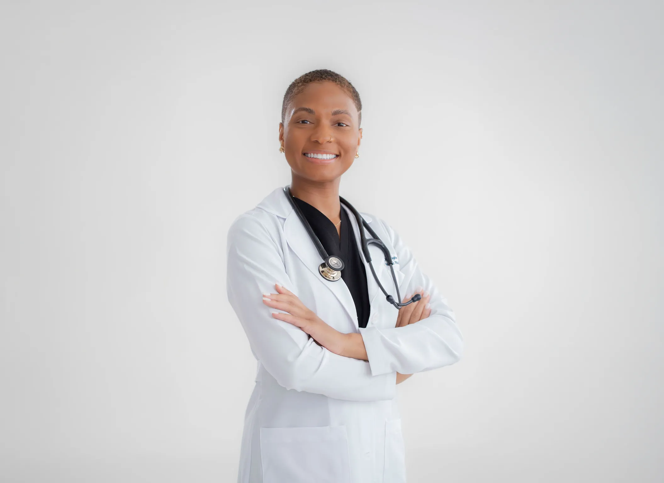 Headshot of Dr. Taylor, a physician and Lead Specialist at Texas Dizziness Center, smiling confidently with arms crossed.