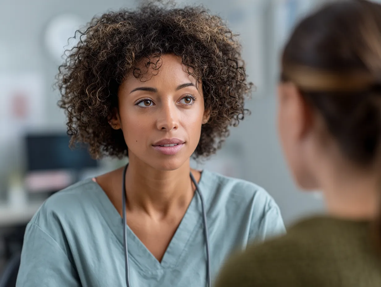 Close-up, flat-lay view of a pen on a stack of white paper, with eyeglasses and subtle decor in a soft-focus background, suggesting organized patient forms or a professional administrative process.
