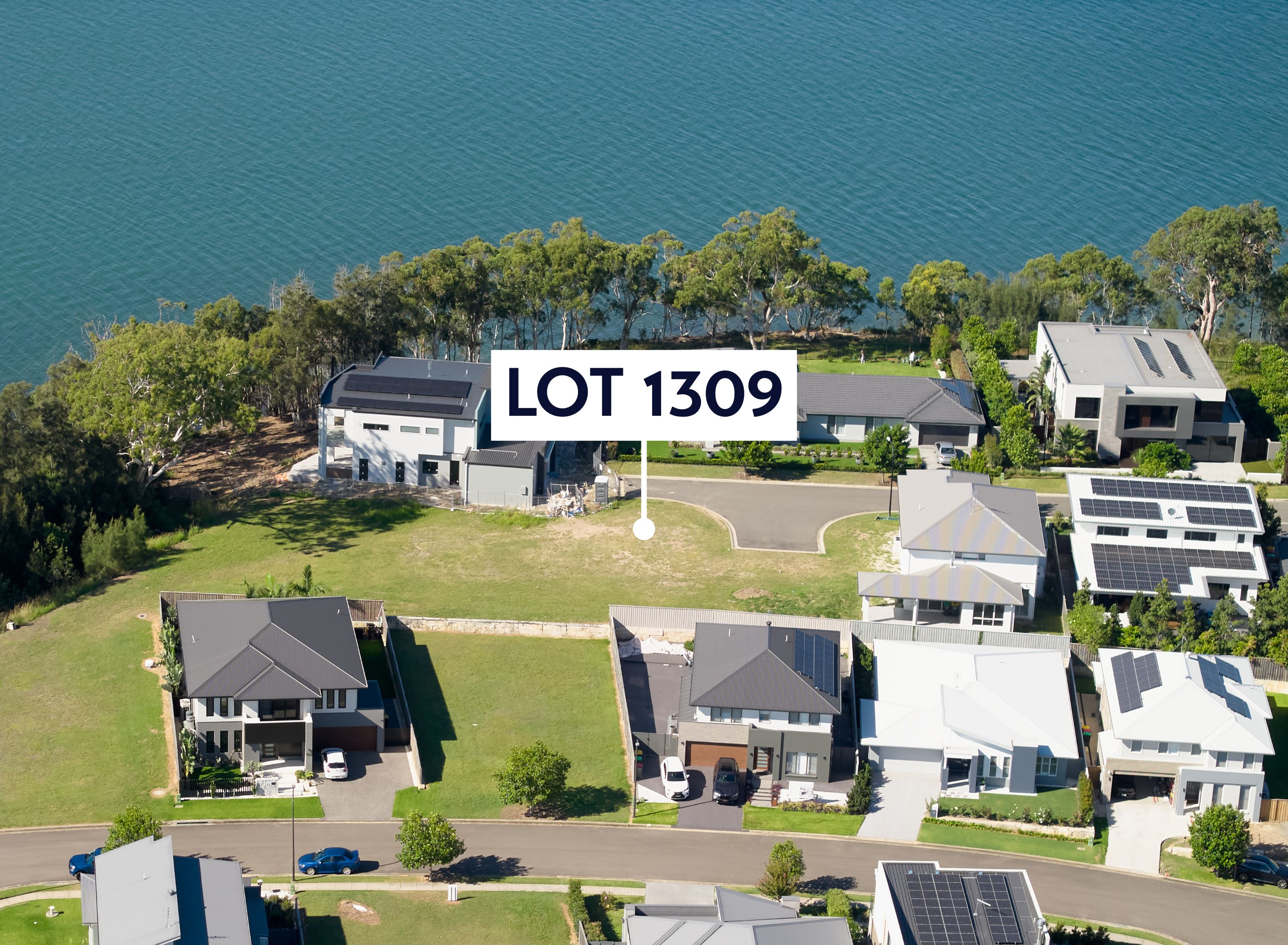  Aerial with a marker pointing at lot 1309. The aerial shows the lot is near the water. The Aerial is taken from the south