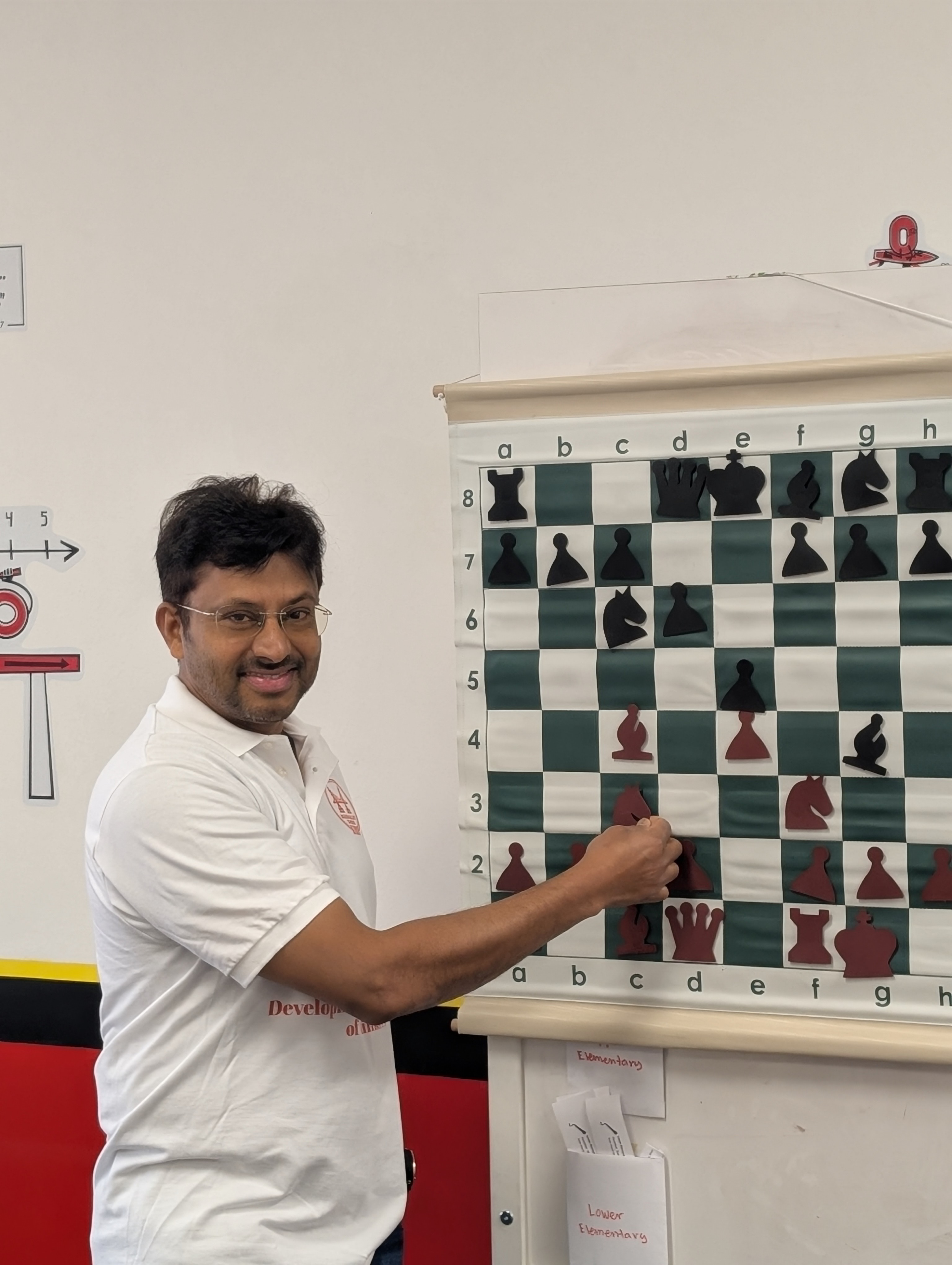 Coach Jonathan guiding two young students during a chess lesson at the Sunnyvale location