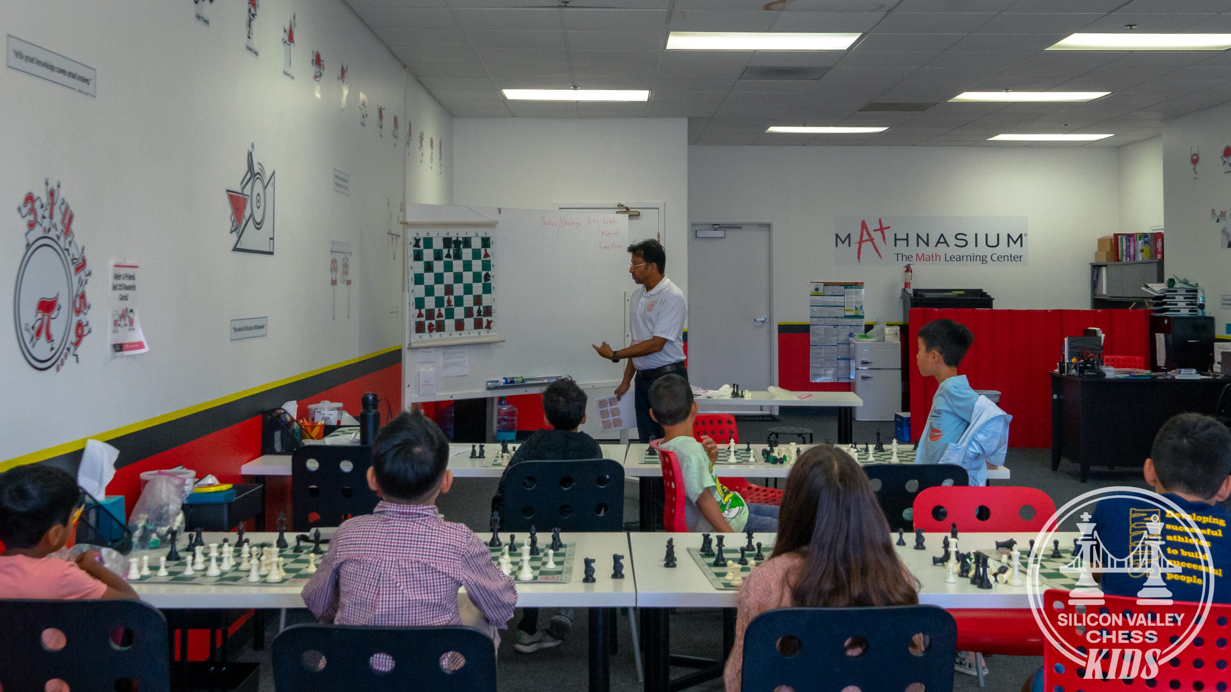 Coach DJ explaining chess concepts on demo board during Sunnyvale class at SV Chess Kids