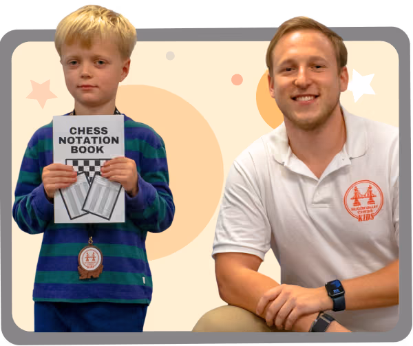 Coach Viktor beside a kid holding a chess notation book as part of the after school program of Silicon Valley Chess Academy.