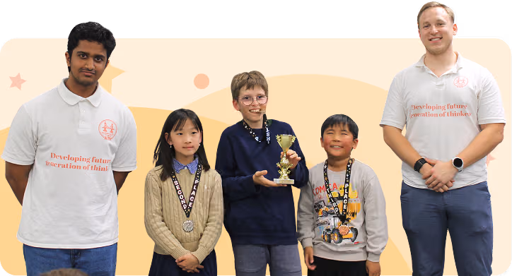 A group of diverse children and a smiling instructor celebrate together, holding up chess trophies and medals.
