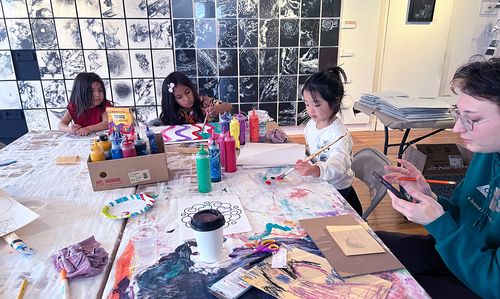 Kids painting together in a community creative space