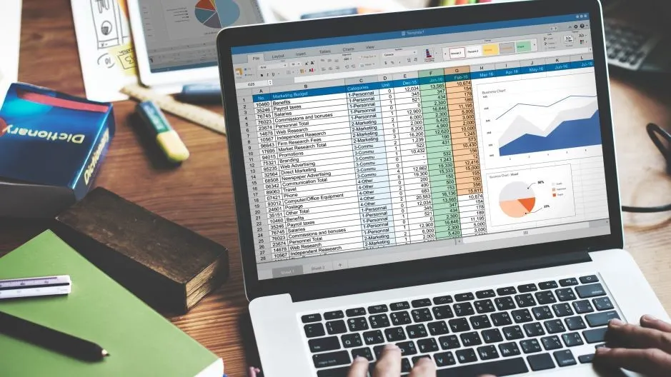 Person working on a spreadsheet with static business data, representing outdated manual software systems.