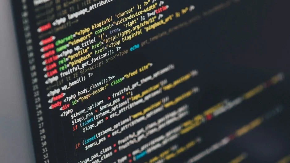 Close-up of colorful programming code on a screen representing no-code AI development.