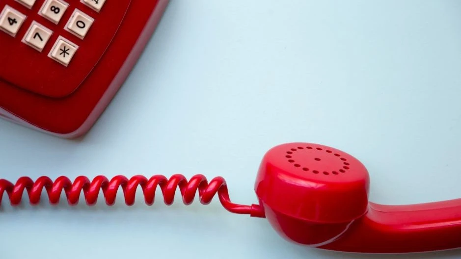 Red dialer phone kept on-hold depicting buying-time chat scripts