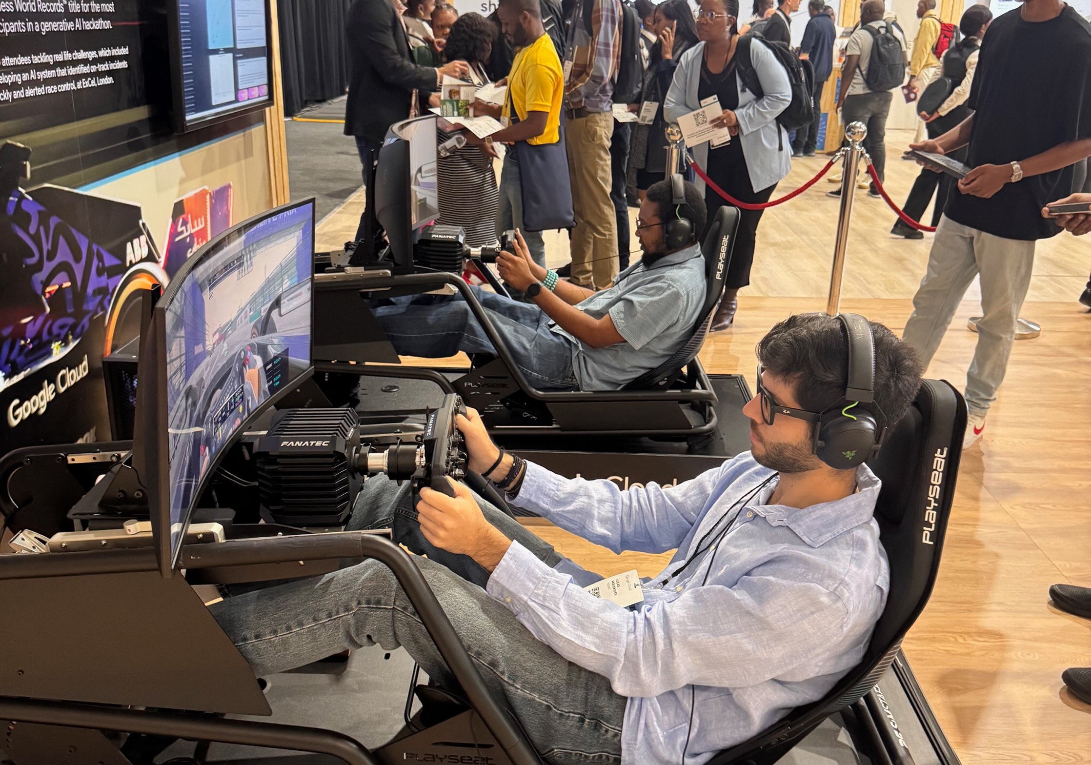 Man in black hoodie working on a laptop displaying a graphic design software at a desk in an office at Tecbot.
