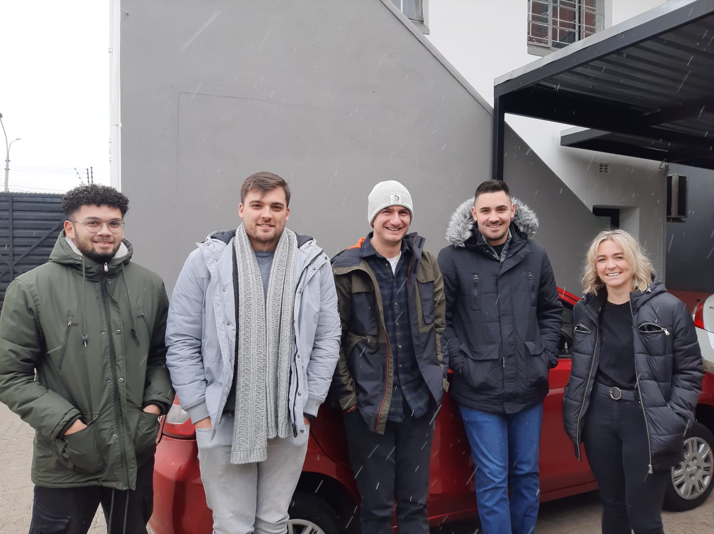 3D Tecbot logo. Three transparent glass petals arranged in a triangular shape casting soft shadows on a gray background.