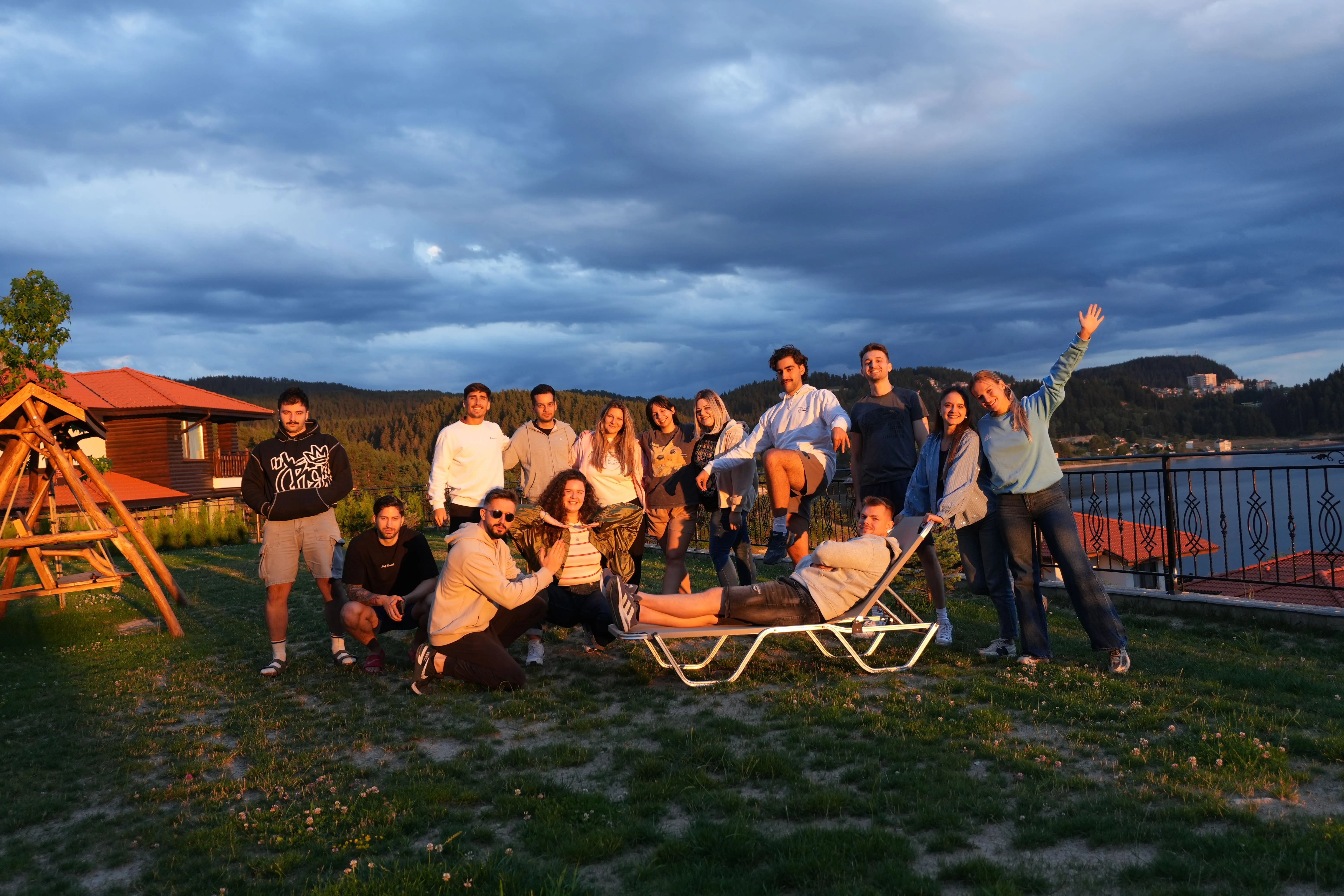 Hypergen team members posing together outdoors at sunset near a lake.
