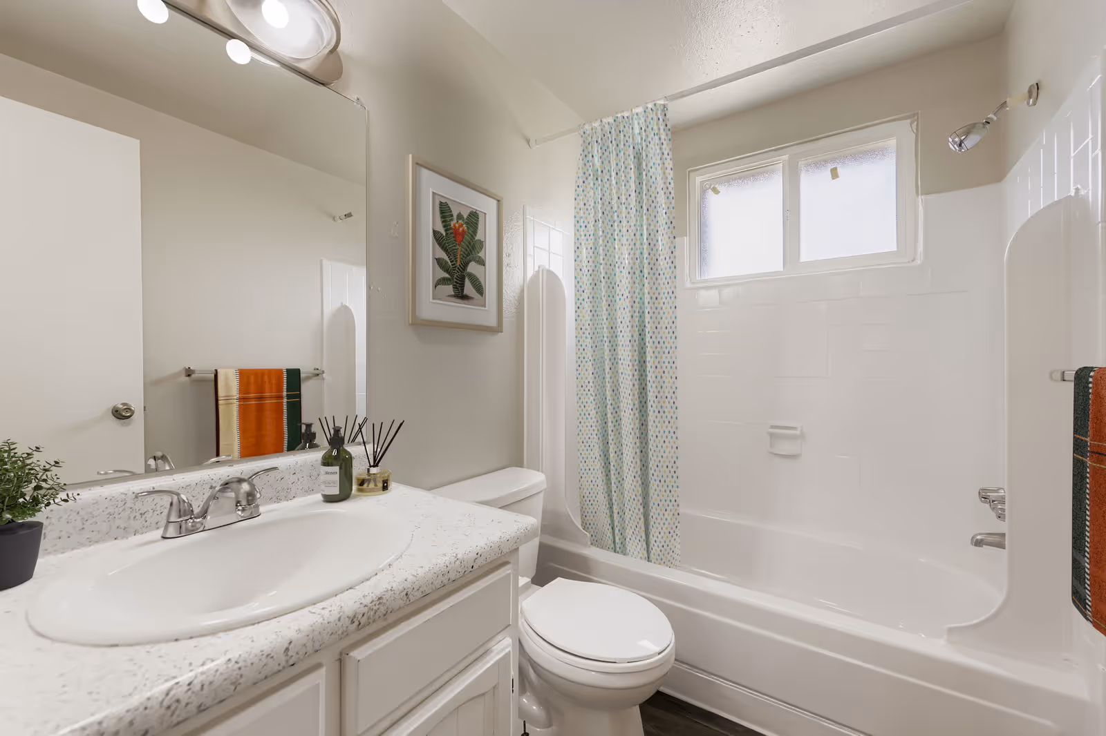 living room area facing the kitchen with bar stools in cut out bar area