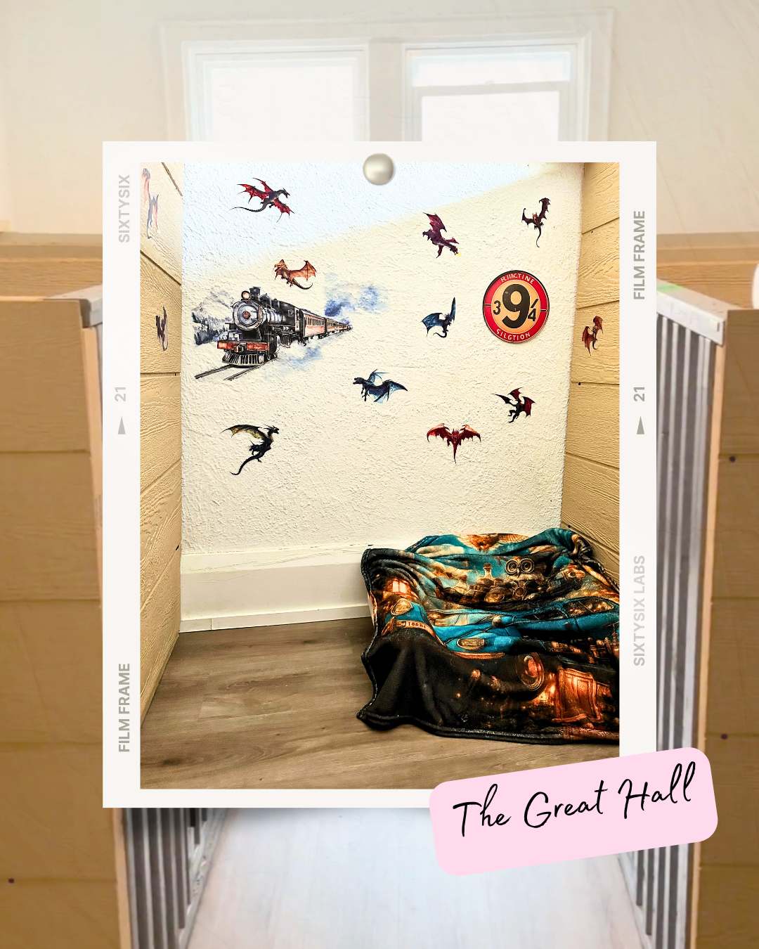 Corner of a room decorated with Harry Potter themed wall decals featuring a steam train, dragons, and a Platform 9 ¾ sign.
