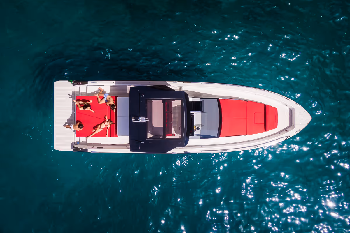 Top view of the Fiart 43 Seawalker at anchor with guests enjoying the spacious sunpads and walkaround deck