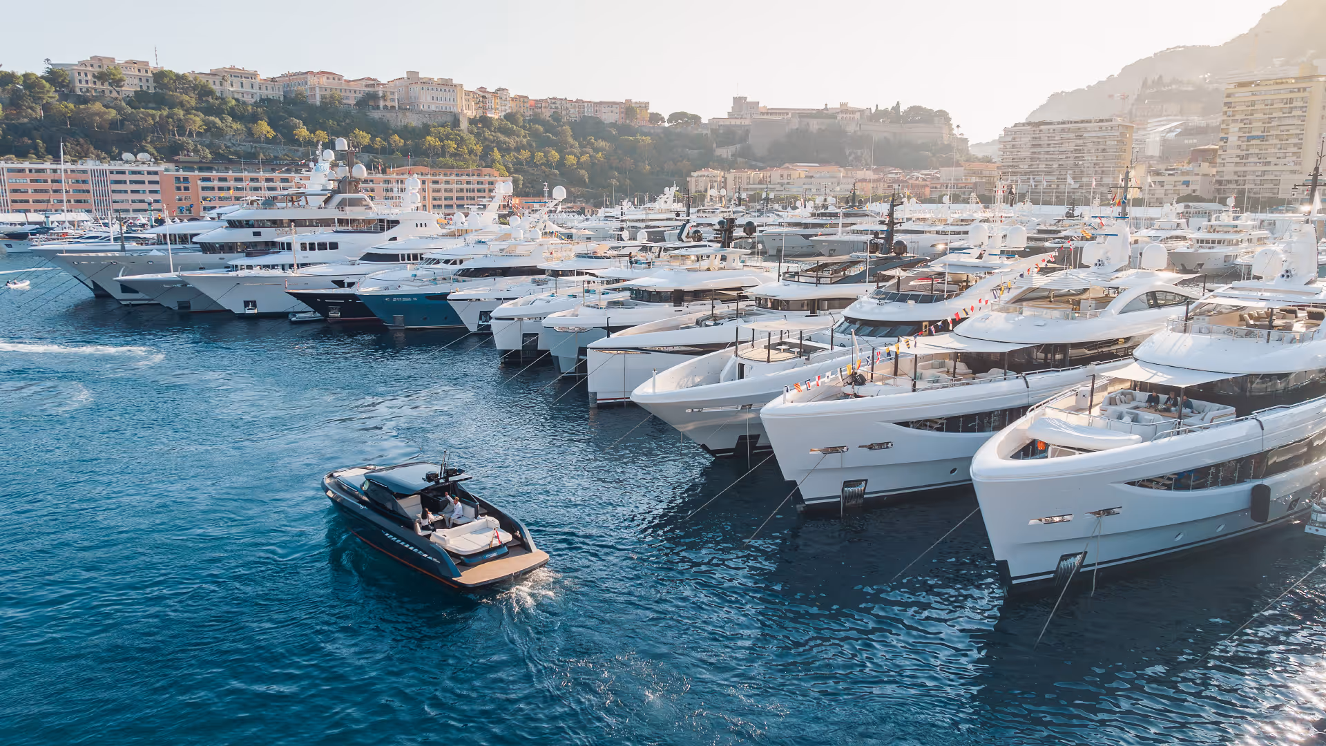 Luxury yachts moored in Port Hercule, Monaco – a prime destination for bespoke yacht charters on the French Riviera.