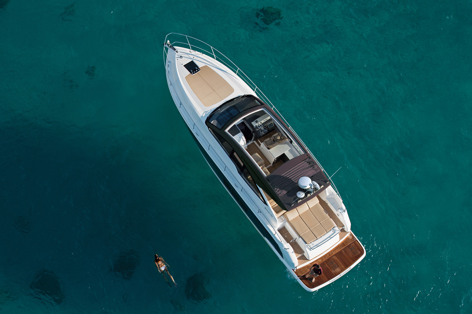 An aerial view of the Targa 50 Open charter anchored, revealing spacious sunbathing areas and stylish deck.