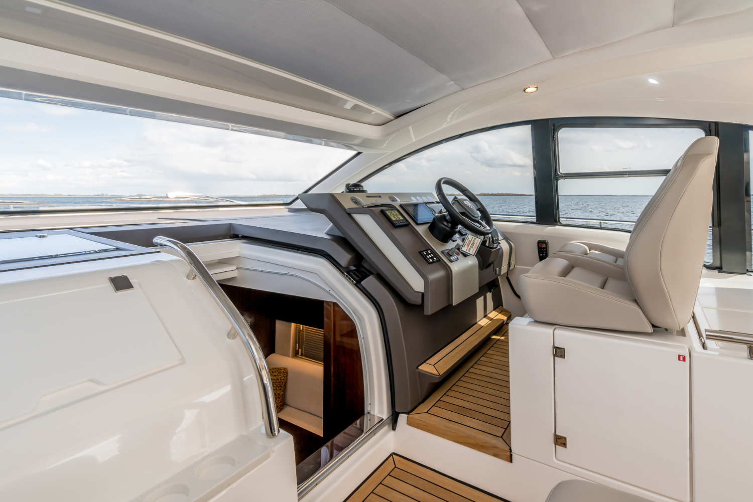 Cockpit of the Targa 50 Open charter showcasing the steering controls and panoramic sea views for navigation.