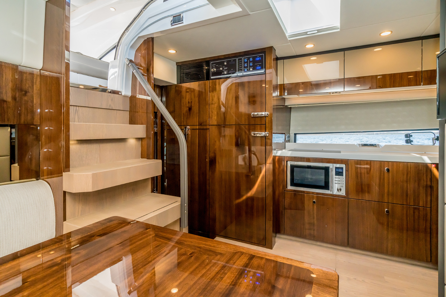 Kitchen area inside the Targa 50 Open charter, highlighting wooden finishes and modern appliances for amenities.