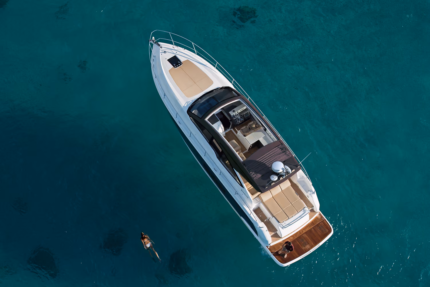 An aerial view of the Targa 50 Open charter anchored, revealing spacious sunbathing areas and stylish deck.